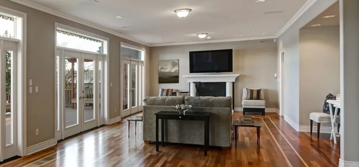 Finished living room with polished hardwood flooring