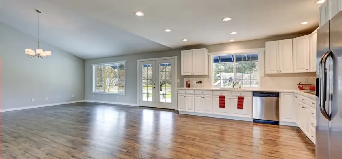 Laminate flooring installed beside a bright kitchen